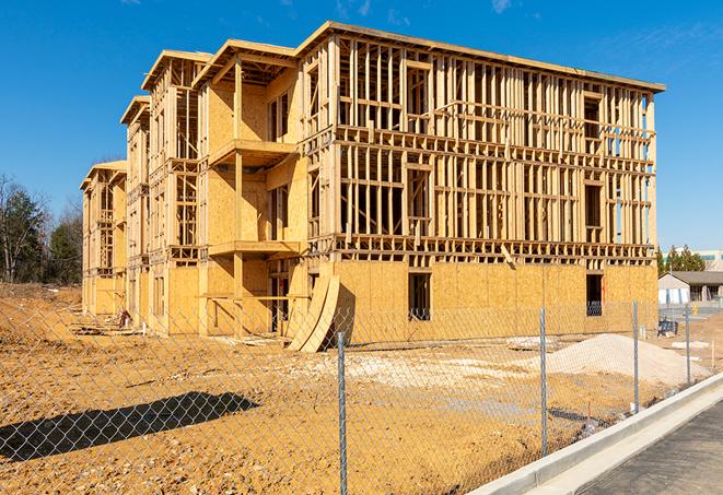 a close-up of temporary chain link fences enclosing a construction site, signaling progress in the project's development in Holly Hill